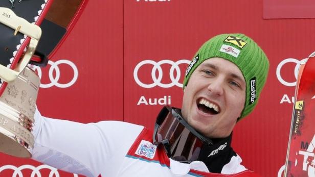 Marcel Hirscher of Austria celebrates on the podium with a bell after winning the Alpine Skiing World Cup men&#039;s slalom ski race in Adelboden January 13, 2013. REUTERS/Pascal Lauener (SWITZERLAND - Tags: SPORT SKIING)