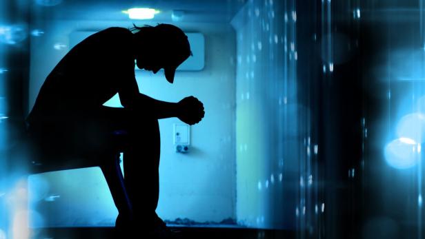 Silhoutte of desperate teenager praying on abstrac…