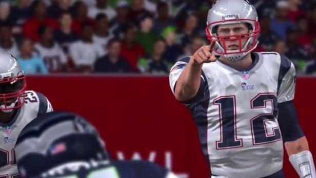 Ein American-Football-Spieler der New England Patriots zeigt mit dem Finger auf dem Spielfeld.
