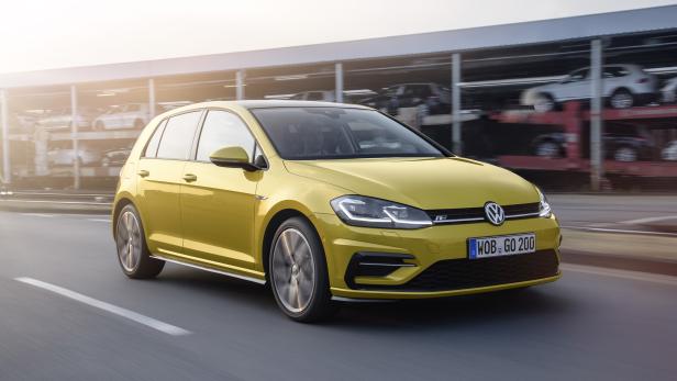 Ein gelber VW Golf fährt auf einer Straße.