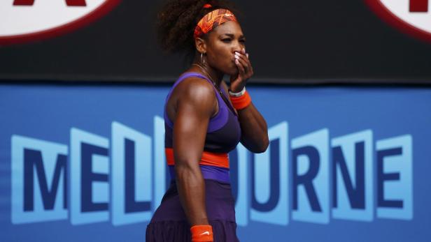 Serena Williams of the U.S. holds her mouth after hitting herself with her racket during her women&#039;s singles match against Garbine Muguruza of Spain at the Australian Open tennis tournament in Melbourne January 17, 2013. REUTERS/David Gray (AUSTRALIA - Tags: SPORT TENNIS)