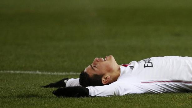 Real Madrid's James Rodriguez lies on the ground d