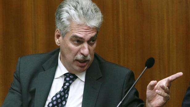 Austrian Finance Minister Schelling gestures durin