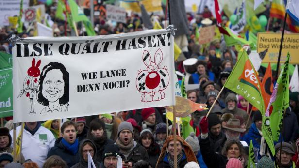 epa03544372 People hold a banner reading &#039;Ilse tortures rabbits! How long will it last?&#039; as they demonstrate against the practices of the agribusiness in Berlin, Germany, 19 January 2013. Ilse Aigner is the German Agriculture Minister. According to the organizers, around 25,000 protesters gathered at Paul Loebe House to demonstrate under the motto &#039;We are fed up with the agribusiness&#039;. EPA/Marc Tirl