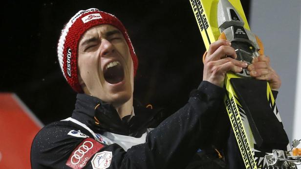 epa03526465 Third placed Stefan Kraft of Austria reacts during the Flower-Ceremony after the final at the fourth stage of the four hill jump in Bischofshofen, Austria, 06 January 2013. EPA/GEORG HOCHMUTH