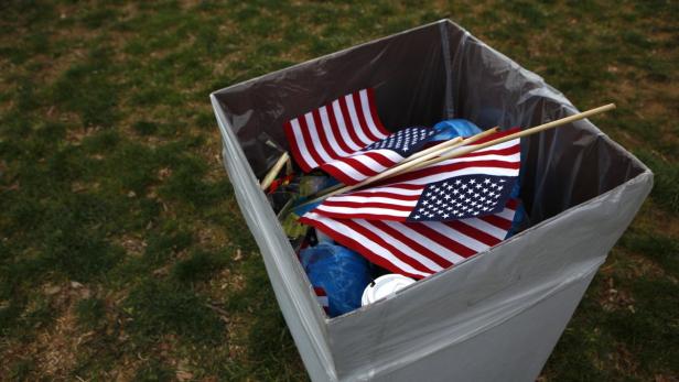 Flags are seen in a trash can on the National Mall during the 57th inauguration ceremonies for U.S. President Barack Obama and Vice President Joe Biden on the West front of the U.S. Capitol, in Washington January 21, 2013. REUTERS/Eric Thayer (UNITED STATES - Tags: POLITICS SOCIETY)
