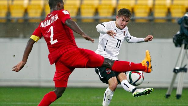 Zwei Fußballspieler kämpfen um den Ball während eines Spiels.