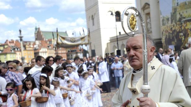 Ein Priester führt eine Prozession von Kommunionskindern in Warschau an.