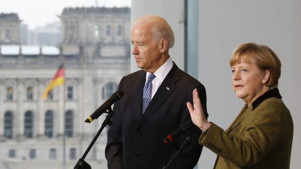 German Chancellor Angela Merkel and U.S. Vice President Joe Biden leave after making a statement to the media before talks in Berlin February 1, 2013. REUTERS/Tobias Schwarz (GERMANY - Tags: POLITICS)
