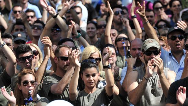 Eine Menschenmenge jubelt und pfeift mit Trillerpfeifen.