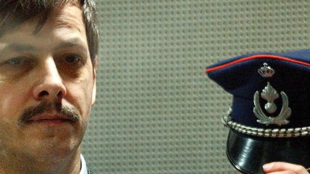 Convicted child rapist Marc Dutroux stands in the dock in the Arlon courthouse, southeast Belgium, in this March 8, 2004 file photo. When the bodies of two schoolgirls were found dumped by a railway line in Belgium in June 2006, public horror rang to cries of &quot;not again&quot; as the country confronted memories of Dutroux&#039;s paedophile killings. To match feature BELGIUM CRIME REUTERS/Thierry Roge/Files (BELGIUM)