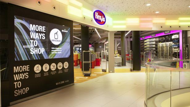 Der Eingang zu einem Hervis-Sportgeschäft mit Hinweisen auf „Click & Collect“.