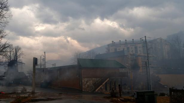 Ein bewölkter Tag in einer Stadt mit Gebäuden und Rauch in der Luft.