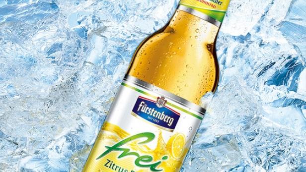 Eine Flasche Fürstenberg „Frei“ Zitrus Radler liegt im Eis.