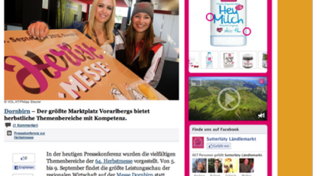 Zwei Frauen präsentieren ein Plakat für die „Herbstmesse“ in Dornbirn.