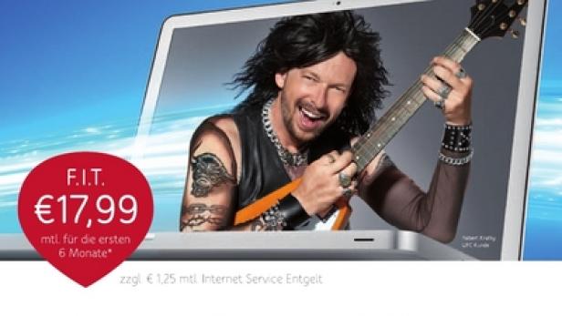 Ein Mann mit Gitarre schaut aus einem Laptop-Bildschirm und wirbt für F.I.T. von UPC.