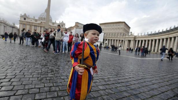 A child dressed as a Swiss Guard stands in St Peter&#039;s Square at the Vatican February 12, 2013. Pope Benedict stunned the Roman Catholic Church on Monday when he announced he would stand down, the first pope to do so in 700 years, saying he no longer had the mental and physical strength to carry on. REUTERS/Max Rossi (VATICAN - Tags: RELIGION) ATTENTION EDITORS : ITALY&#039;S LAW REQUIRES THAT THE FACES OF MINORS ARE MASKED IN PUBLICATIONS WITHIN ITALY
