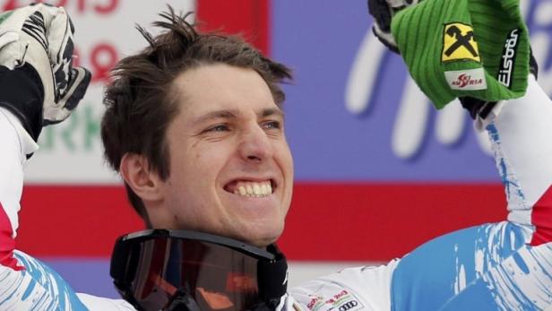 Gold medallist Marcel Hirscher of Austria celebrates on the podium during the medal ceremony of the men&#039;s Slalom race at the World Alpine Skiing Championships in Schladming February 17, 2013. REUTERS/Leonhard Foeger (AUSTRIA - Tags: SPORT SKIING TPX IMAGES OF THE DAY)
