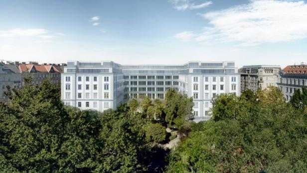 Ein modernes Gebäude mit großen Fenstern, teilweise von Bäumen verdeckt.