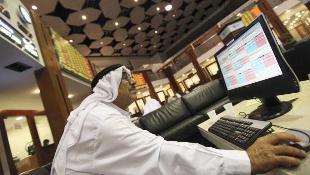 epa03838920 (FILE) A file photo dated 22 May 2012 shows a Gulf investor following the stock market developments on a monitor screen at the Dubai Financial Market in Dubai, United Arab Emirates. The Dubai Financial Market General Index on 27 August 2013 dropped by 7 % over concerns of the escalating Syrian crisis and possible military action by the United States and its allies. EPA/ALI HAIDER