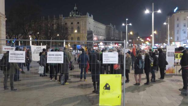 Eine abendliche Demonstration mit Schildern zum Thema Menschenrechte in Wien.