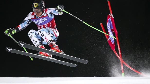 Ein Skirennläufer springt während eines Rennens über eine Piste.