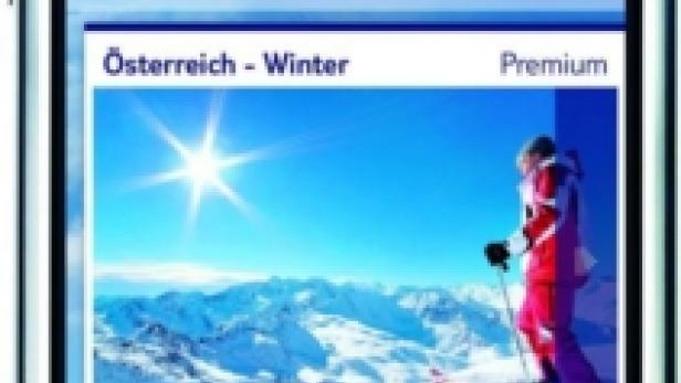 Ein iPhone zeigt die TUI Meine Guides App mit einem Winterbild von Österreich.