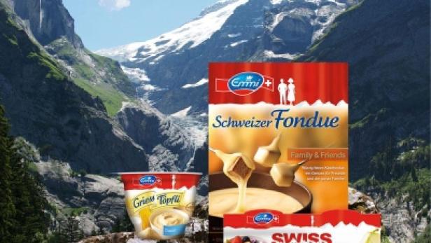 Emmi Schweizer Fondue, Griesstöpfli und Swiss Müsli vor einer Bergkulisse.