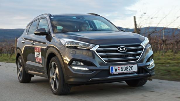 Ein grauer Hyundai Tucson fährt auf einer Landstraße.