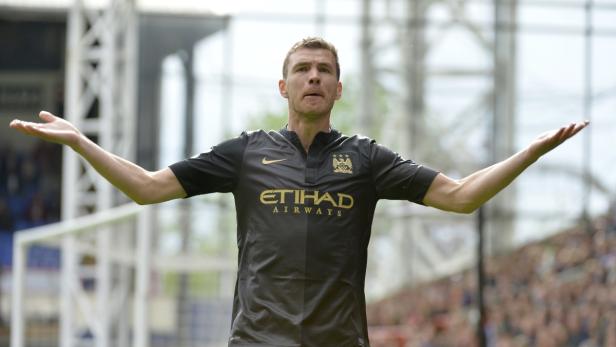 Ein Fußballspieler von Manchester City jubelt mit ausgestreckten Armen.