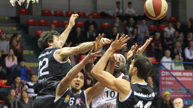 Basketballspieler kämpfen um den Ball während eines Spiels.
