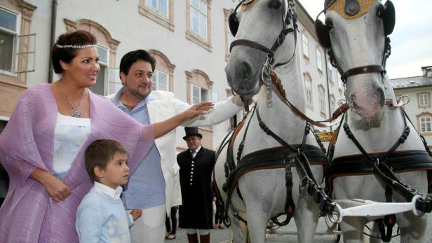 epa04360274 Russian-born Austrian soprano Anna Netrebko (L) with her son Tiago (front) and her fiance, Azerbaijani tenor Yusif Eyvazov (2-L), pose for photographs with the horses of a horse-drawn carriage after they announced their official engagement during a brief ceremony in Salzburg, Austria, 19 August 2014, Salzburg. Netrebko had already announced her engagement plans on a social media network earlier this year. Tiago is the son of Netrebko and her former partner, bass bariton Erwin Schrott from Uruguay. EPA/FRANZ NEUMAYR