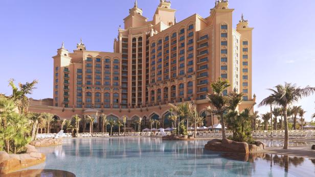Das Atlantis Hotel in Dubai mit einem großen Pool im Vordergrund.