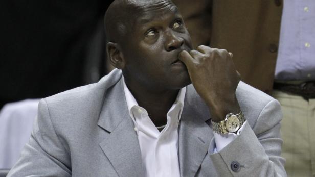 Michael Jordan in einem grauen Anzug bei einem Basketballspiel.