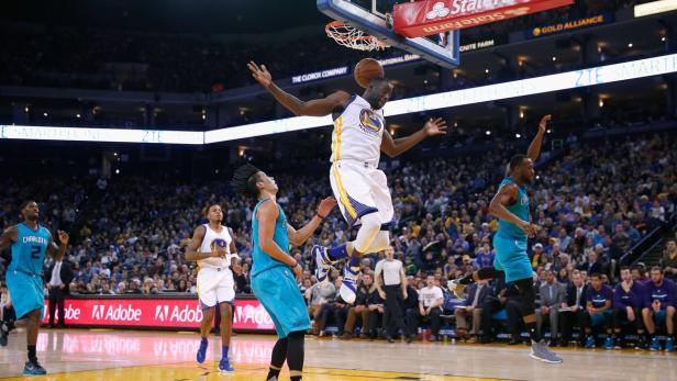 Ein Basketballspieler balanciert einen Ball auf dem Kopf während eines Spiels.