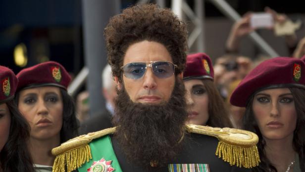 Sacha Baron Cohen als Admiral General Aladeen, umgeben von weiblichen Leibwächtern.