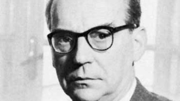 Ein Schwarzweißporträt von Paul Celan mit Brille.