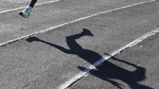 A sportsman casts a shadow on a race track while t Symbolbild