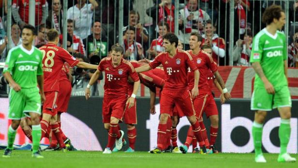 Fußballspieler des FC Bayern München feiern auf dem Spielfeld.