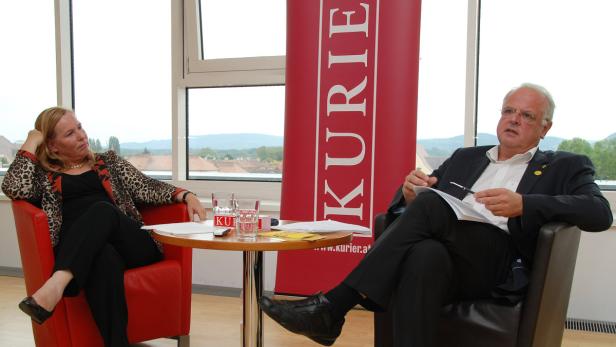 Eine Frau und ein Mann sitzen in Sesseln bei einer Veranstaltung des „Kurier“.