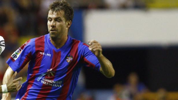 Ein Fußballspieler im blau-roten Trikot des FC Valencia während eines Spiels.
