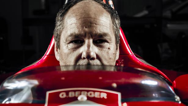 Gerhard Berger hinter dem Steuer eines roten Formel-1-Rennwagens.