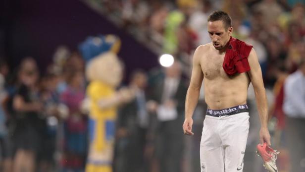 Ein erschöpft wirkender Franck Ribéry mit nacktem Oberkörper und einem Trikot über der Schulter verlässt das Spielfeld.