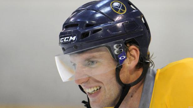 Ein lächelnder Eishockeyspieler mit Helm der Buffalo Sabres.