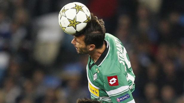 Ein Fußballspieler köpft einen Ball während eines Spiels.