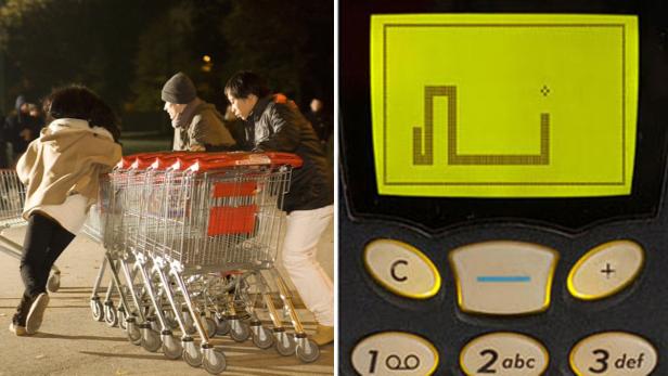 Menschen schieben Einkaufswagen, während ein Handy das Spiel „Snake“ zeigt.