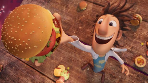 Flint Lockwood aus „Wolkig mit Aussicht auf Fleischbällchen“ hält einen riesigen Hamburger hoch.