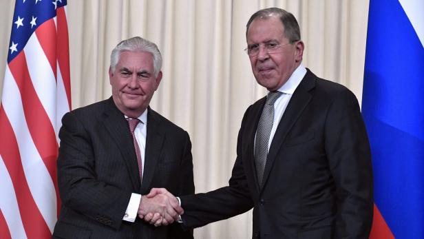 links Rex Tillerson, der gibt Sergej Lawrow die Hand, beide in Anzug und Krawatte