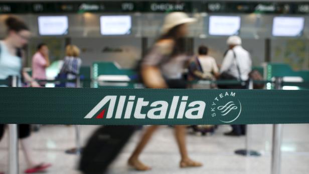 People walk in the Alitalia departure hall at Fiumicino international airport in Rome, Italy, July 24, 2015. REUTERS/Max Rossi/File Photo