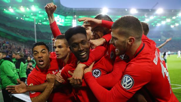 Spieler von Eintracht Frankfurt feiern gemeinsam auf dem Rasen.